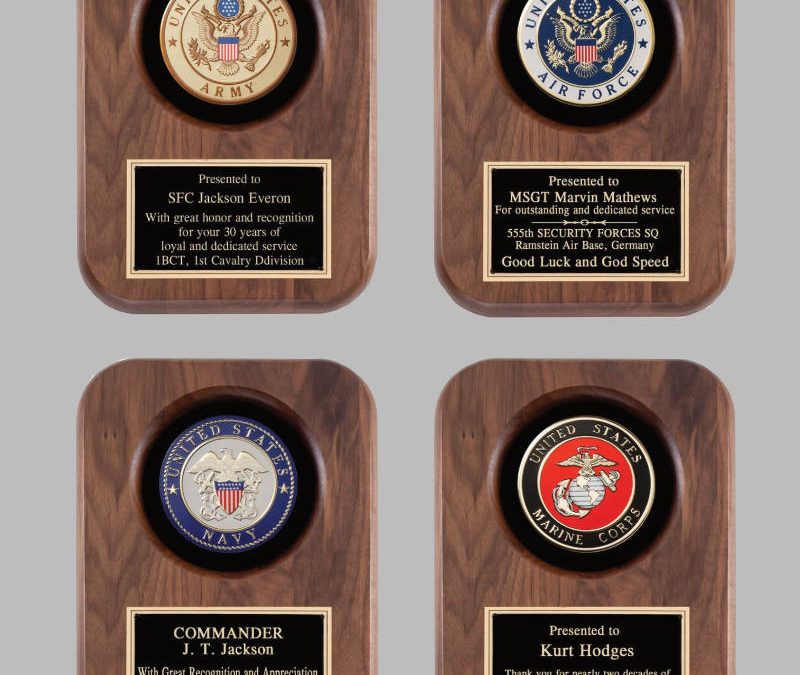 Four wooden plaques with emblems and engraved dedication plates for U.S. Army, Air Force, Navy, and Marine Corps.
